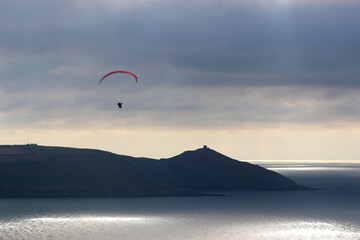 Storm Clouds and paraglider above Whitsand Bay, Cornwall	