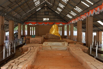 Ancient stone carving, reclining Buddha image in the past.  Sema Thammachak Temple in Thailand