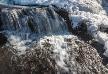 A small waterfall on the river in the spring