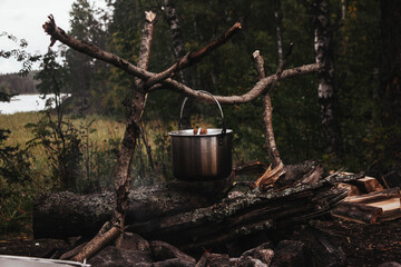 Campfire cooking pot in autumn forest