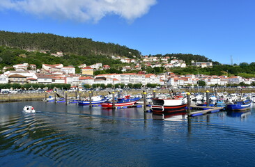 Fototapeta na wymiar Harbor and coastal village with galician fishing boats and sailing boats at famous Rias Baixas in Galicia Region. Muros, A Coruña, Spain.