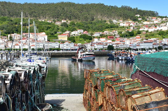 Harbor and coastal village with galician fishing boats and sailing boats at famous Rias Baixas in Galicia Region. Muros, A Coruña, Spain.