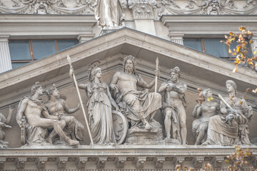 Scenes from Roman Empire Age at the front gate portal of State University building in Vienna, in its historical and touristic downtown, Austria.