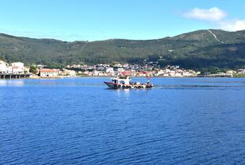Fototapeta na wymiar Bay with galician fishing boat in a harbor at famous Rias Baixas in Galicia Region. Muros, A Coruña, Spain.