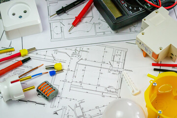 Flat lay composition with electrician's tools on house plan. Space for text