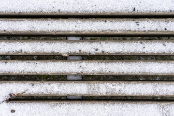 Snow-dusted wooden grating. Background.