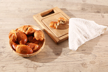 Healthy food - pies in a basket on a wooden table. Delicious culinary products.
