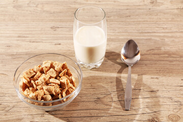 Healthy food - a glass of milk and a quick breakfast in a plate are on a wooden table.
