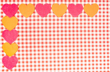 background with red and white Vichy fabric for Valentine's Day with pink and orange hearts. valentines day concept