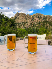 Two beers with an mountainous view
