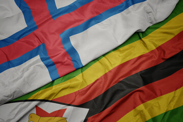 waving colorful flag of zimbabwe and national flag of faroe islands.