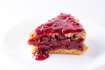 pie with apples and raspberry jam on a white plate