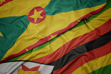 waving colorful flag of zimbabwe and national flag of grenada.