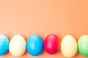 multicolored Easter eggs on a brown background, close-up