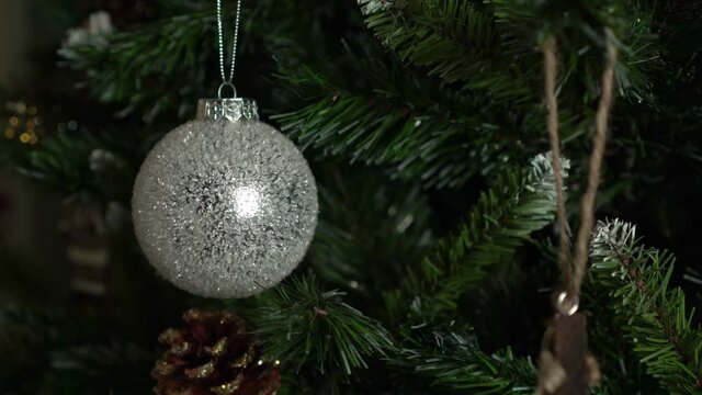 Decorating an artificial Christmas or New Year tree with balls