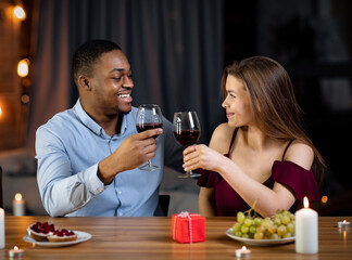 Affectionate Mixed Couple Having Romantic Dinner In Restaurant, Drinking Wine And Smiling