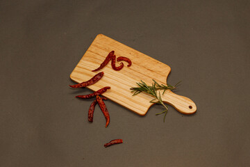 Wood Board With red chili pepper with rosemary ideas