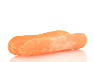One ripe organic, unpeeled carrot, cut in half, close-up, isolated on white.