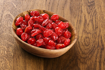 Dried cherries on wooden background.