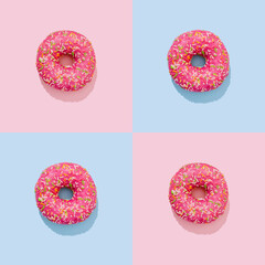 Donut pattern in pink glaze with colorful sprinkleson blue and pink background in pop art style