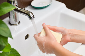 Child washing hands with soap and water. Hygiene concept. Protection against infections and viruses.