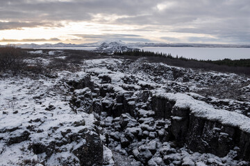 View over the fault line between the North American and Eurasian continental plates on Lake þingvallavatn with the small peninsula of Mjóanes and the island of Sandey in Þingvellir National Park . 