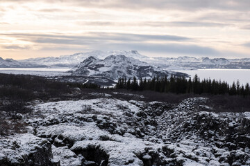 View over the fault line between the North American and Eurasian continental plates on Lake þingvallavatn with the small peninsula of Mjóanes and the island of Sandey in Þingvellir National Park . 