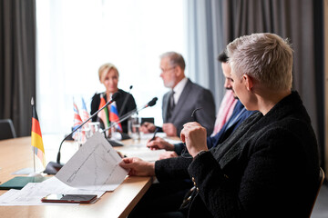 group of diverse business people working and communicating sitting at office desk together, discussing business ideas. in modern boardroom