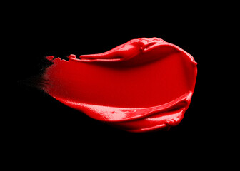 Smudged red lipstick isolated on black background