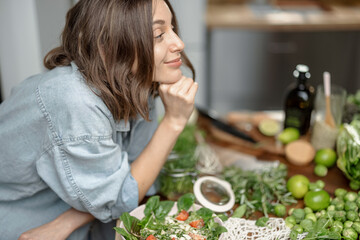 Profile portrait of beautiful young woman enjoy healthy clean food on the kitchen. Have diet salad with vegetable on the table. High quality photo © rh2010