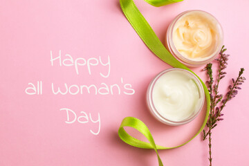 Composition with cream and ribbon on color background