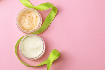 Bottles with cosmetic for facial and body care on light background