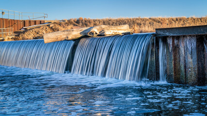 river diversion dam on St Vrain Creek in northern Colorado near Platteville, winter scenery