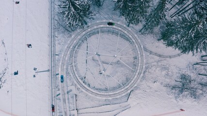 Speed Fun rodelbahn in the forested area in mountains. ski resort on winter daytime Background of spruce forest in snow. Concept of active, extreme winter recreation in mountains.Top Shot. 4K 