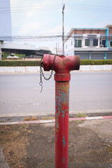 Fototapeta na wymiar Red Fire Hydrant for fire anticipation on sidewalk.