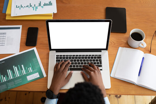 Overhead view of african american woman using laptop while working from home