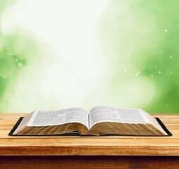 Open vintage christian bible on desk