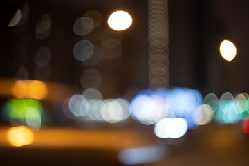Night city lights, blurred image with bokeh and highlights