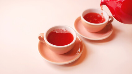 Monochrome image of raspberry or berry tea in cups with a teapot.