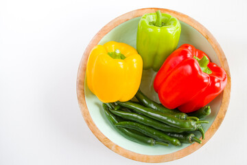 All colors bell pepper and green pepper in the bowl on the white background,