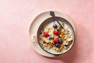 Top view of tasty breakfast with granola, berries and milk