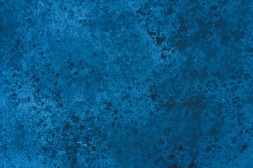 Abstract blue background with concrete texture and spots.