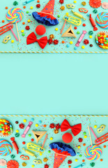 Purim celebration concept (jewish carnival holiday) over blue background. Top view, flat lay