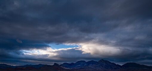 Fototapeta na wymiar Clouds opening over Red Rock