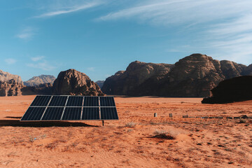 Panel of modern solar battery installed on dry ground in Wadi Rum valley on sunny day