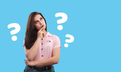 Question sign with a beautiful alarmed woman on pastel background