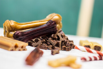 Dog bone for chewing on a green background