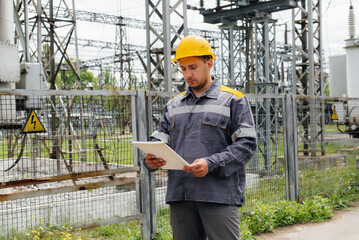 Obraz na płótnie Canvas The energy engineer inspects the equipment of the substation. Power engineering. Industry