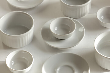 Minimalist monochrome dish and plate white pattern on white background, tableware layout design background texture, modern art design concept