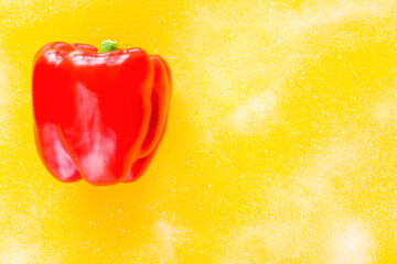 One red bell pepper on the yellow background, colorful vegetable, isolate on the white